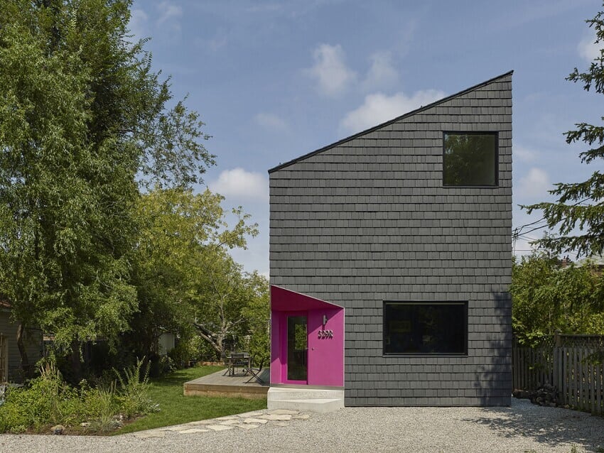Angular home with pink door and Enviroshake Aged Cedar being used as siding