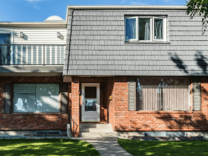 Mansard roof style home with Enviroshake silvered cedar shake composite.