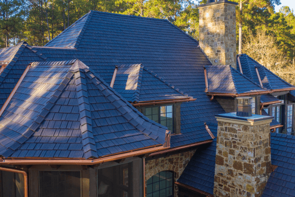 Custom blue Enviroshake synthetic cedar shingles with premium copper flashing installed on modern luxury home.