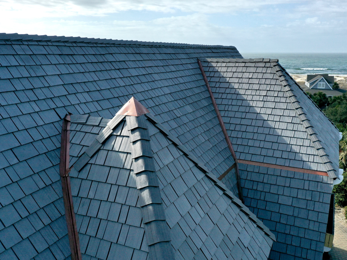 Coastal home with Enviroshake Silvered Cedar on the roof along with copper flashing and accents.