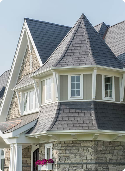 An artistic turret style roof with Enviroslate Charcoal Grey faux slate roofing